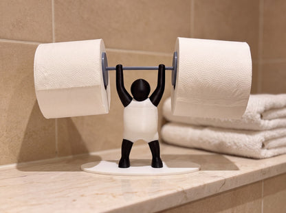 Strongman toilet roll holder on a marble bathroom shelf beside folded white towels