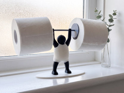 Strongman toilet roll holder on a bathroom windowsill in soft morning light