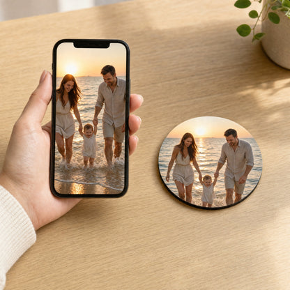 Phone showing a family beach photo next to a round coaster printed with the same photo